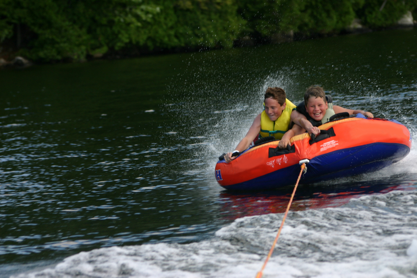 Two people are on a water raft in the lake.