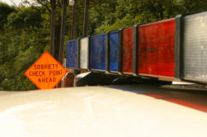 A police car with the words " sobriety check point ahead ".