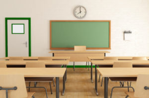 A classroom with desks and chairs, a chalkboard and a clock.