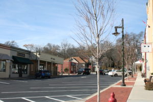 A street with cars parked on the side of it.