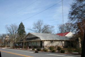 A building with trees and power lines in the background.