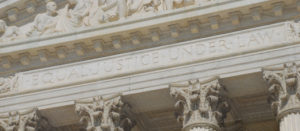 A close up of the words justice under an arch