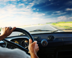 A person driving a car on the road