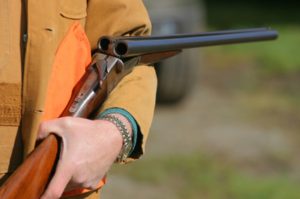 A person holding a rifle in their hand.