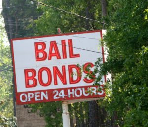 A bail bonds sign on the side of a road.