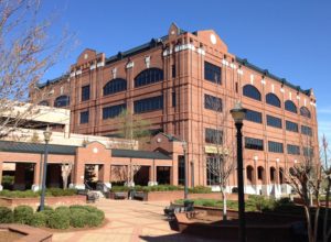 A large brick building with many windows and a courtyard.