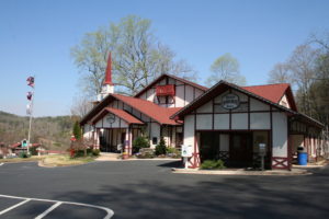 A large building with a red roof and white trim.