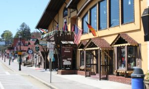 A street view of some buildings and flags.