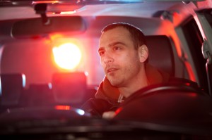 A man sitting in the driver 's seat of a car.