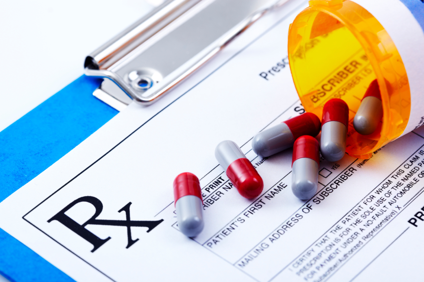 A close up of pills on top of a rx form