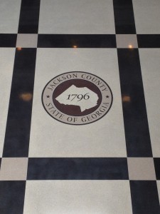 A black and white checkered floor with a logo on it.