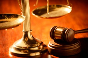 A judge 's gavel and scale on top of a table.