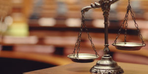 A close up of the scales of justice on top of a table