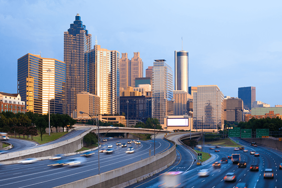 Atlanta skyline with busy highway at dusk.